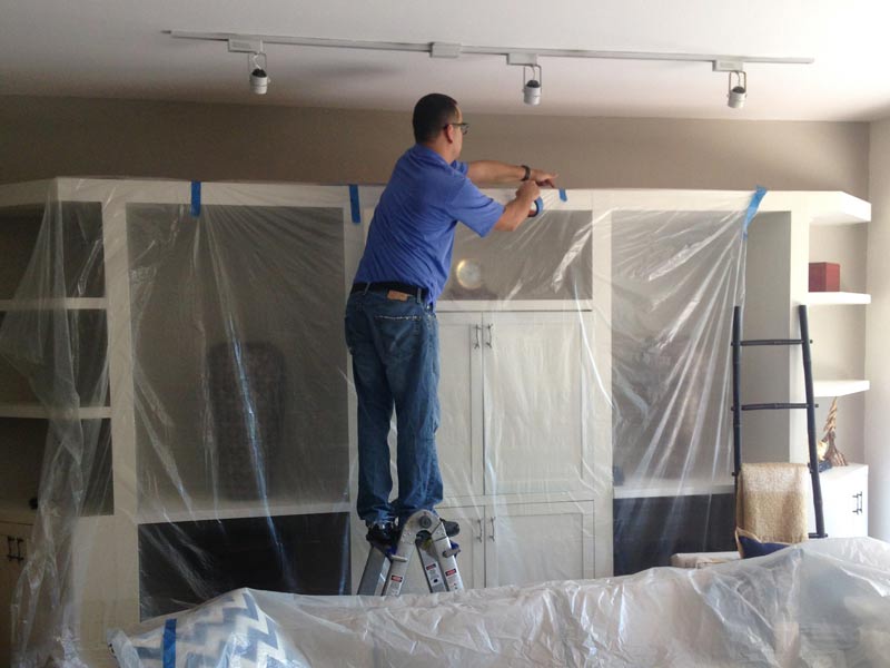 A CleanPro employee covers the home to protect it from the restoration process. 